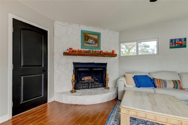 living room with a fireplace and hardwood / wood-style flooring