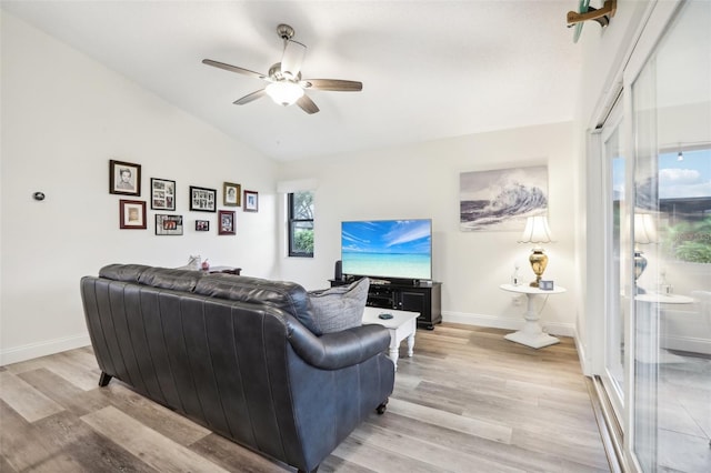 living room with light wood-type flooring, ceiling fan, and vaulted ceiling