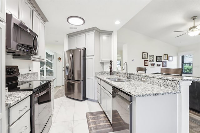 kitchen featuring gray cabinets, kitchen peninsula, sink, and stainless steel appliances