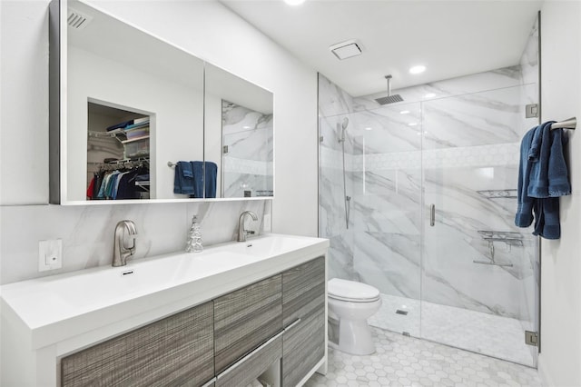 bathroom featuring walk in shower, vanity, and toilet