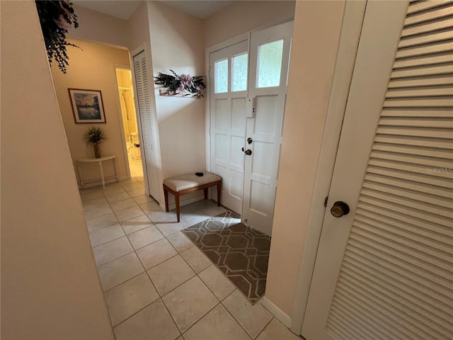 entryway with light tile patterned floors