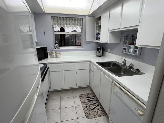 kitchen featuring white cabinets, white appliances, light tile patterned floors, and sink