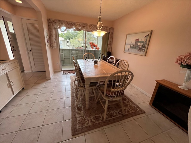 dining area with lofted ceiling and light tile patterned flooring