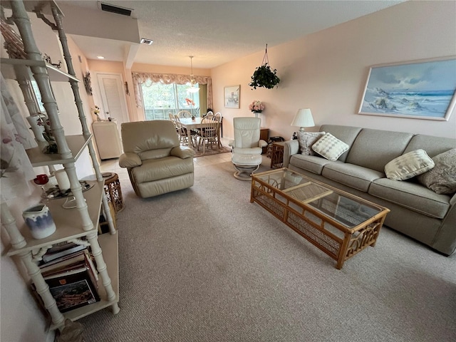 living room featuring carpet flooring and a chandelier