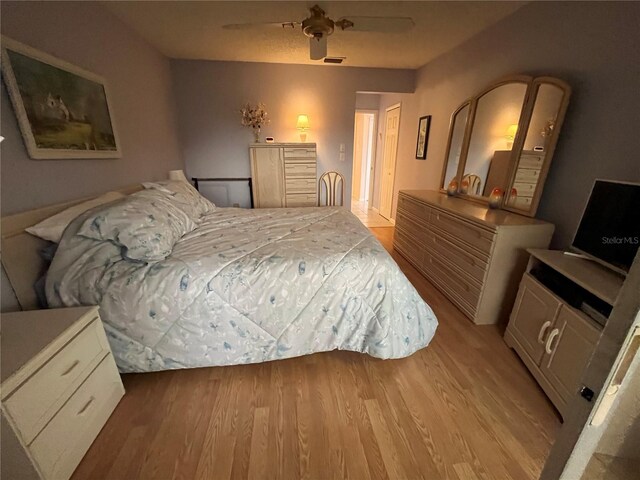 bedroom with ceiling fan and light wood-type flooring