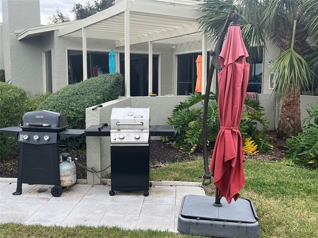 view of patio featuring area for grilling and a pergola