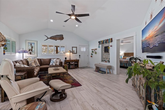 living room with light wood-type flooring, lofted ceiling, and ceiling fan