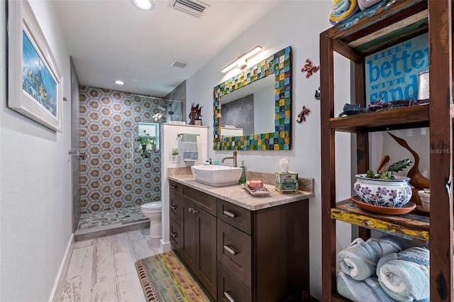 bathroom featuring walk in shower, wood-type flooring, toilet, and vanity