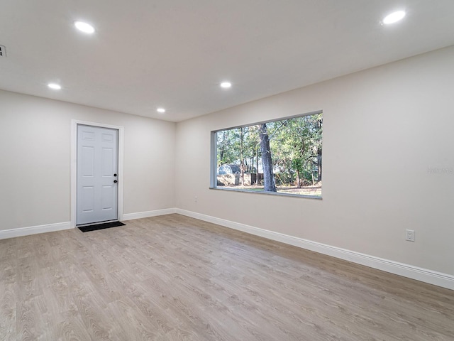 empty room with light hardwood / wood-style flooring