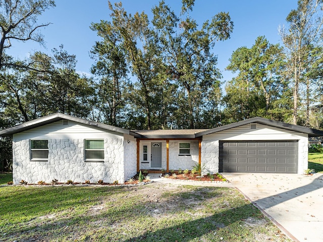 single story home with a garage and a front yard