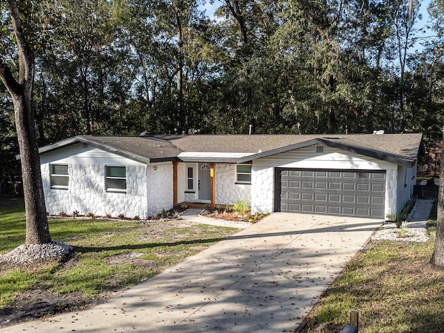 single story home with a garage and a front yard