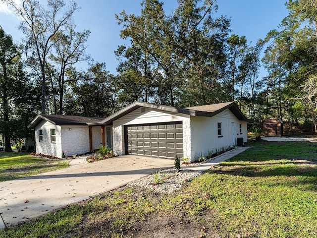 ranch-style home with a garage and a front yard