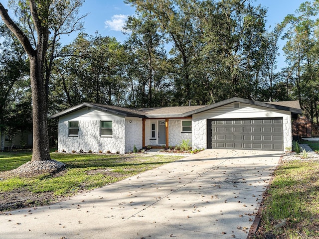 ranch-style house featuring a garage and a front yard