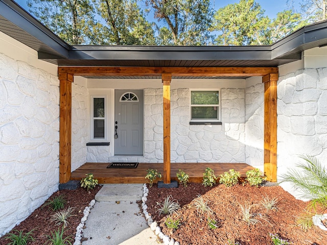 view of exterior entry with a porch