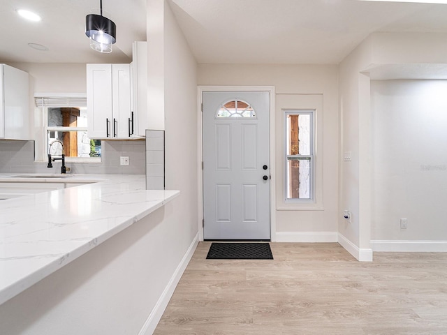 foyer featuring light hardwood / wood-style flooring and a healthy amount of sunlight