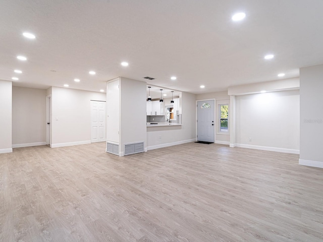 unfurnished living room featuring light hardwood / wood-style floors