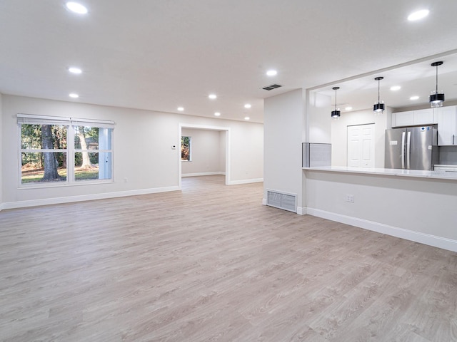 unfurnished living room featuring light hardwood / wood-style floors