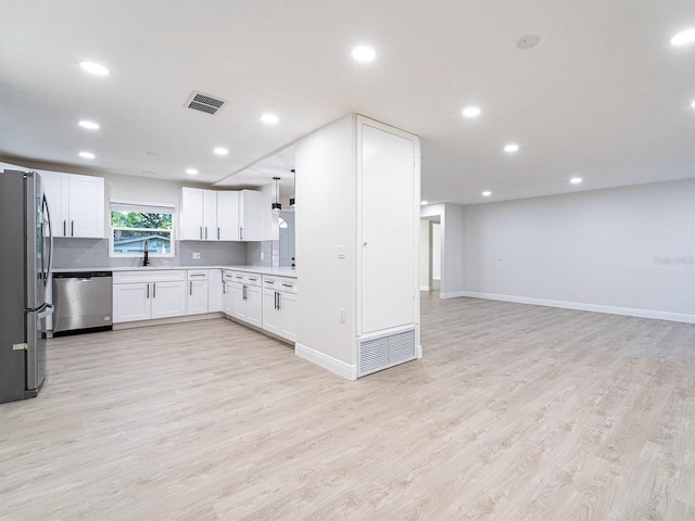 kitchen featuring light wood-type flooring, white cabinets, sink, and stainless steel appliances