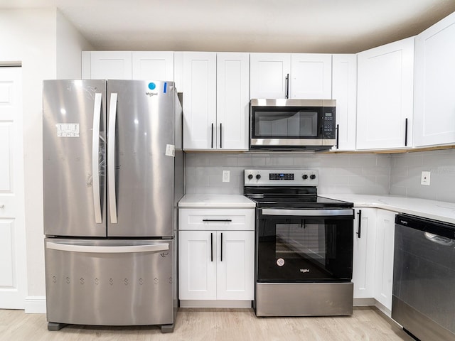 kitchen featuring white cabinetry, light hardwood / wood-style flooring, and appliances with stainless steel finishes