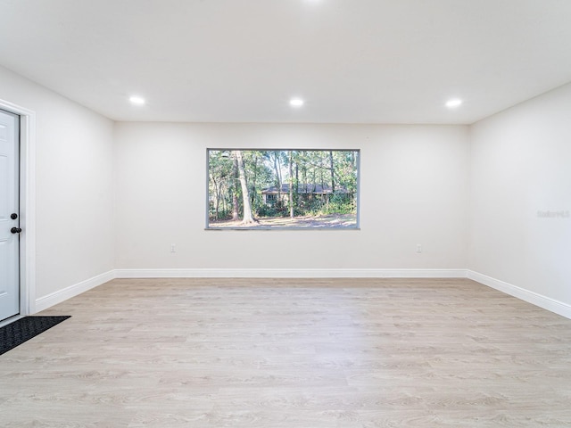 unfurnished room with light wood-type flooring