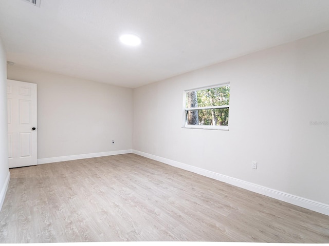 spare room with light hardwood / wood-style flooring