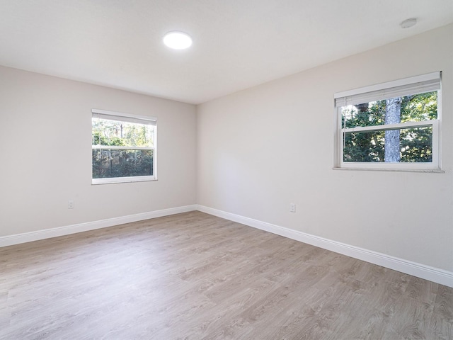 unfurnished room with light wood-type flooring