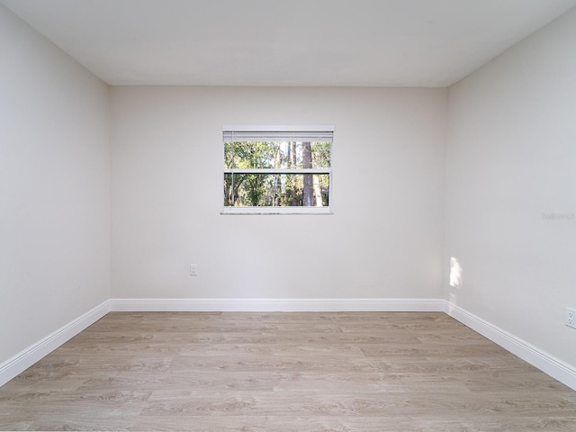 spare room with light hardwood / wood-style flooring