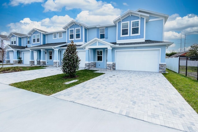 view of front of home featuring a front yard and a garage