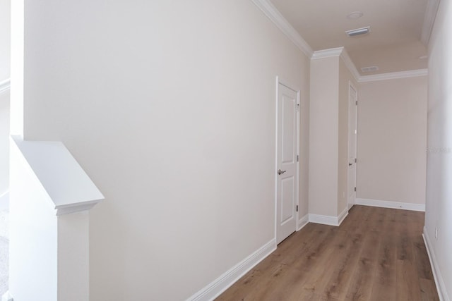 hallway featuring crown molding and hardwood / wood-style floors