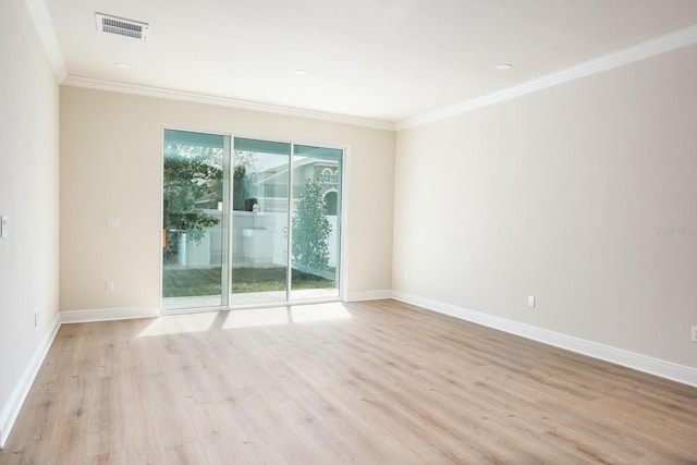 empty room with light hardwood / wood-style floors and crown molding