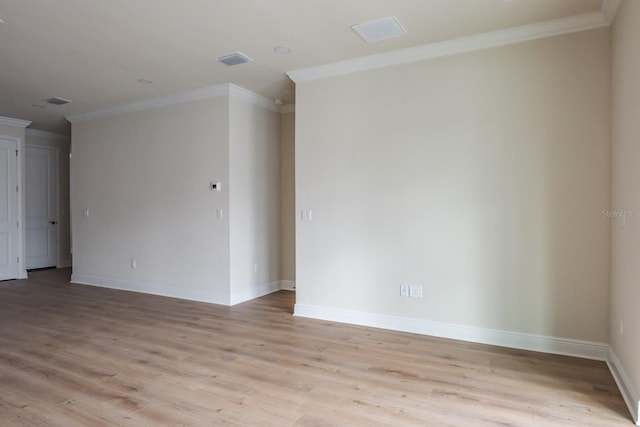 unfurnished room with ornamental molding and light hardwood / wood-style floors