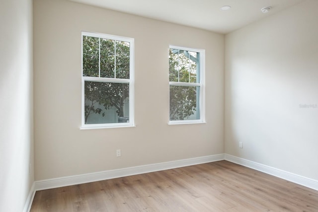 unfurnished room with light wood-type flooring