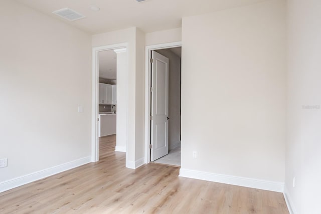 spare room featuring light hardwood / wood-style floors