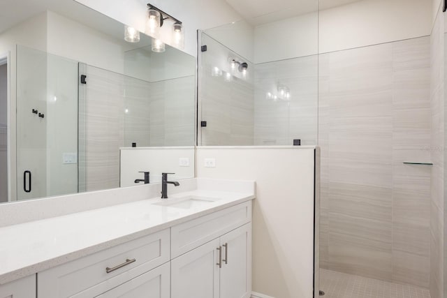 bathroom featuring an enclosed shower and vanity