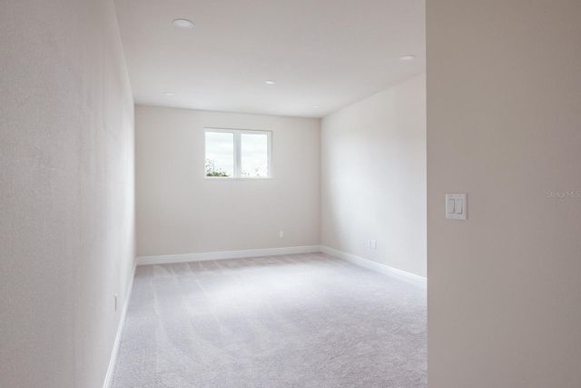 unfurnished room with light colored carpet