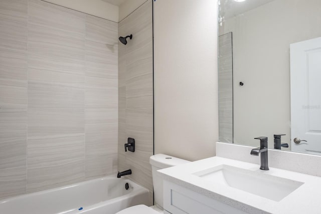 full bathroom with toilet, tiled shower / bath, and vanity