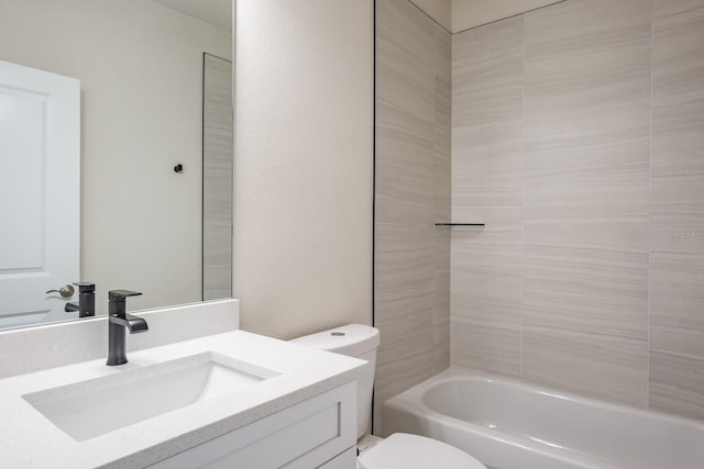 full bathroom with toilet, vanity, and tiled shower / bath