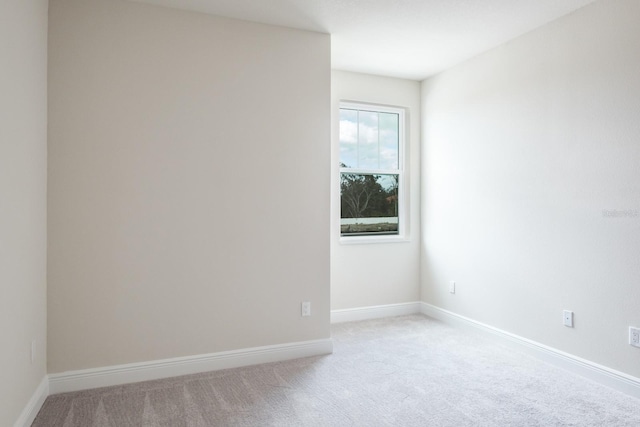 unfurnished room with light carpet