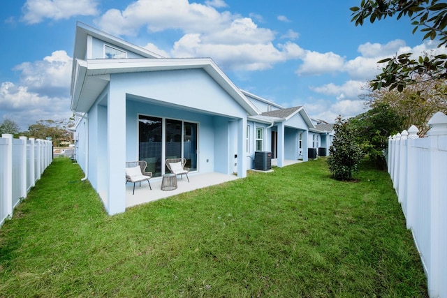 back of property featuring a yard, a patio, and cooling unit