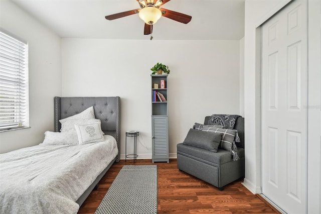 bedroom featuring dark hardwood / wood-style floors, ceiling fan, and a closet