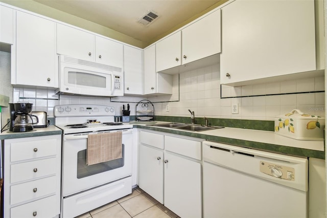 kitchen featuring white cabinets, sink, light tile patterned floors, backsplash, and white appliances