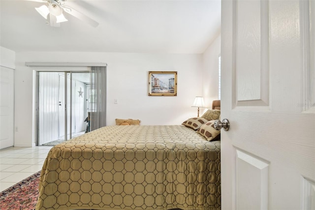 tiled bedroom featuring ceiling fan