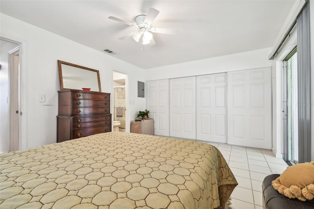 tiled bedroom featuring ceiling fan and a closet