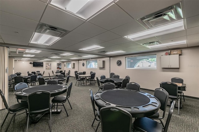 dining area with a paneled ceiling and carpet flooring