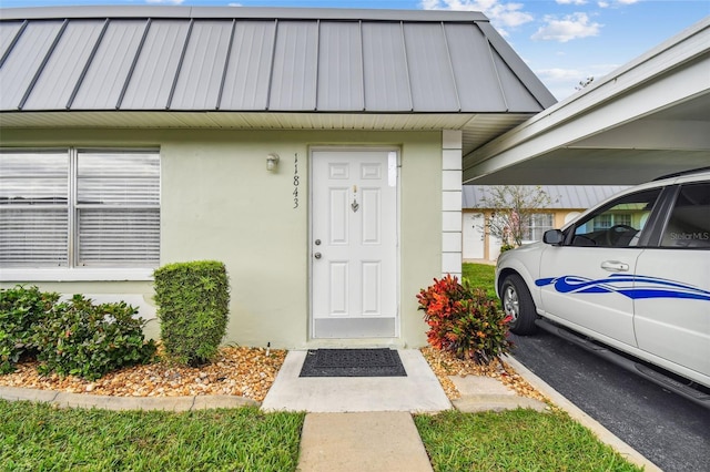 doorway to property with a carport