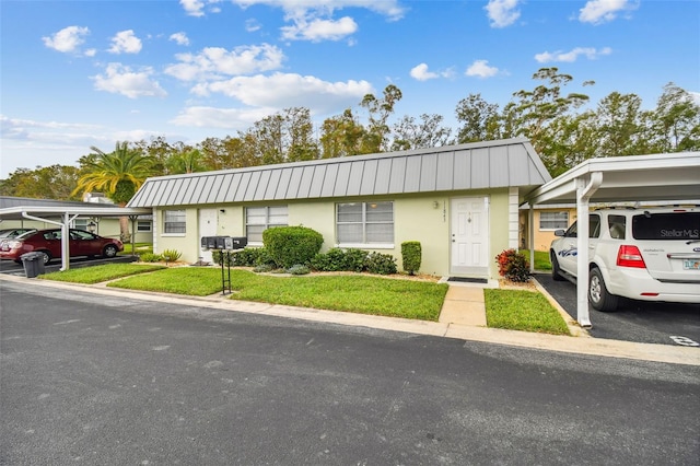 ranch-style house with a front yard and a carport