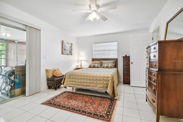 tiled bedroom featuring ceiling fan and multiple windows