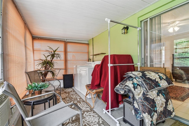 sunroom / solarium with ceiling fan and separate washer and dryer