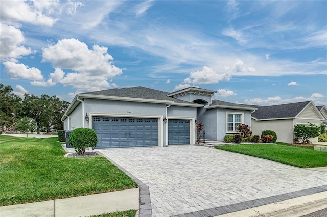 ranch-style home featuring a garage and a front lawn