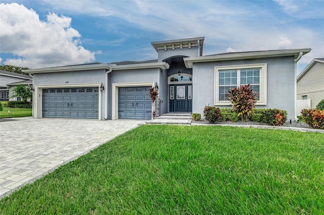 view of front of property with a garage and a front yard